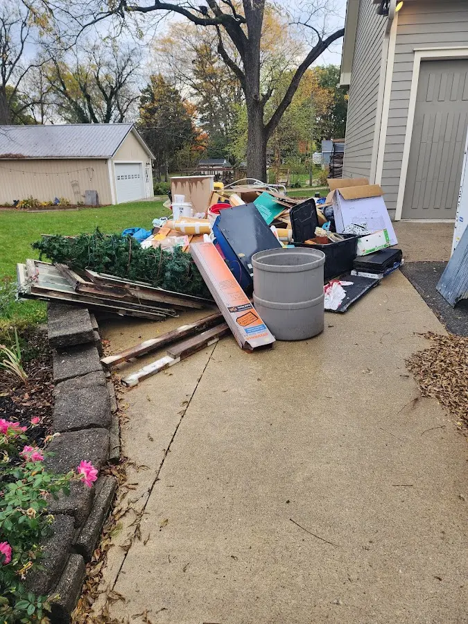 Dumpster being loaded with debris for Estate Cleanout Dumpster Rental in Dorr